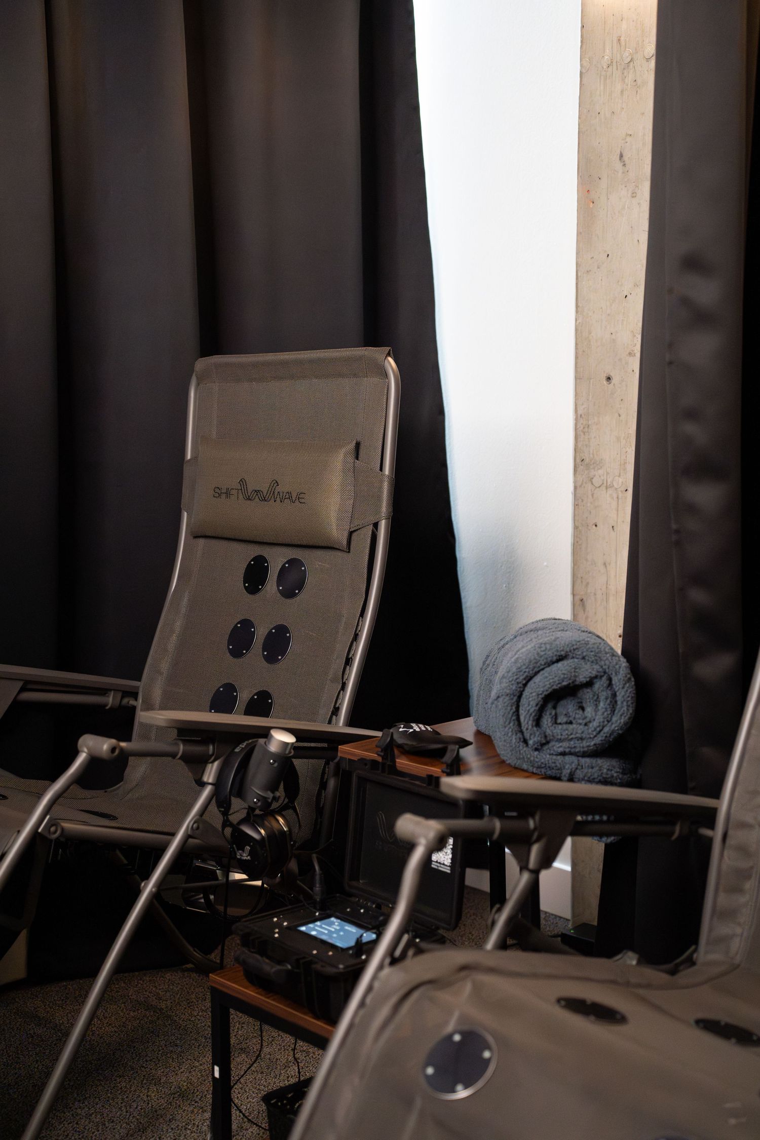 Professional beauty treatment chair with equipment setup in spa room.
