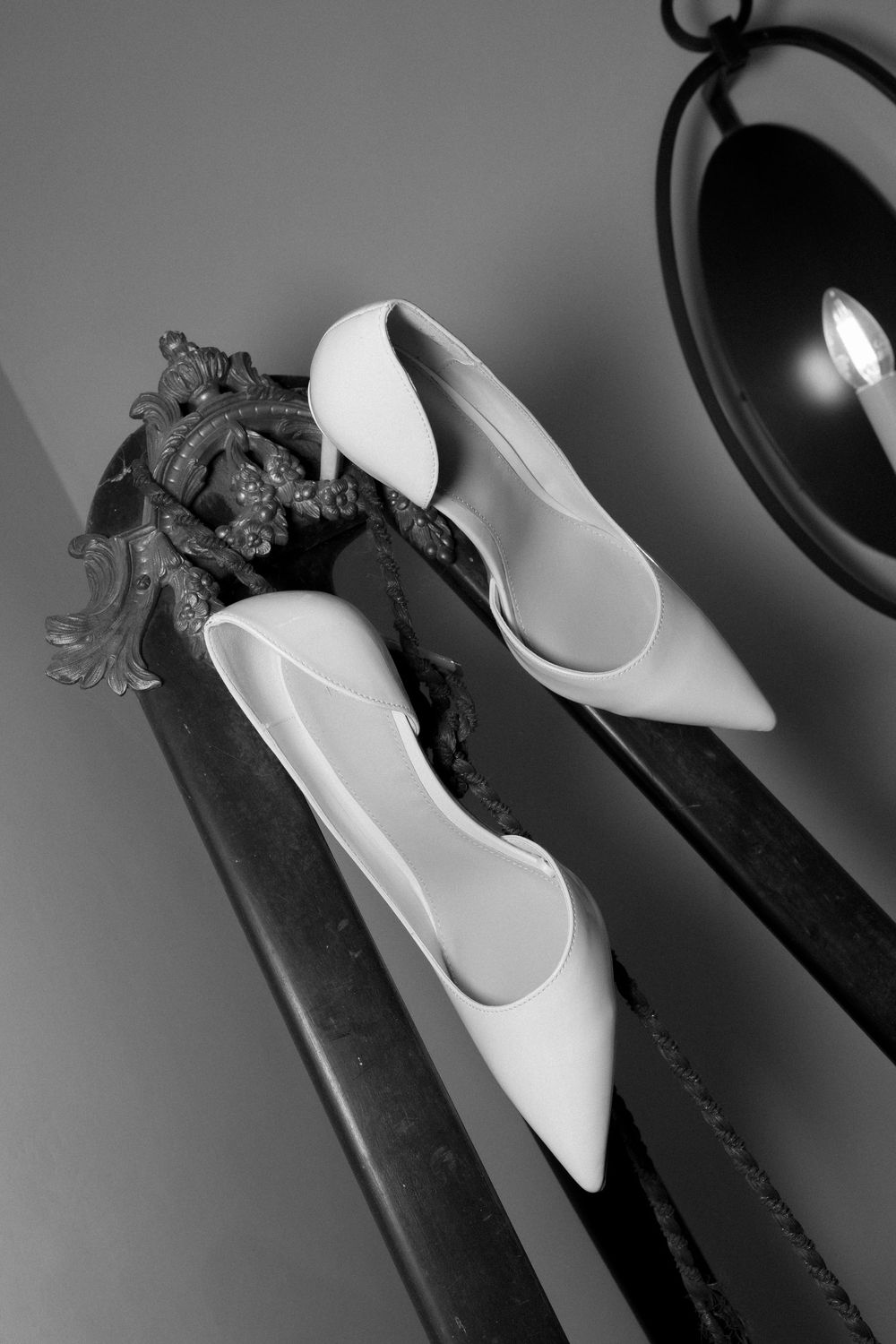 A collection of monochromatic images showing white high heel shoes arranged in an artistic composition.