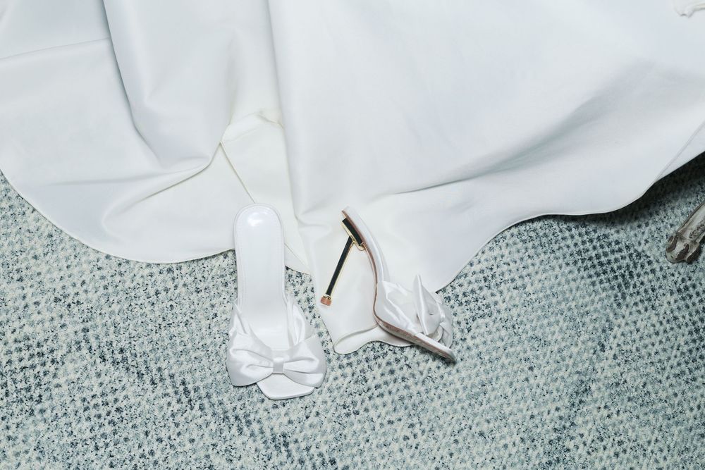 Close-up view of a white button-down shirt collar detail against a textured blue-gray fabric background.