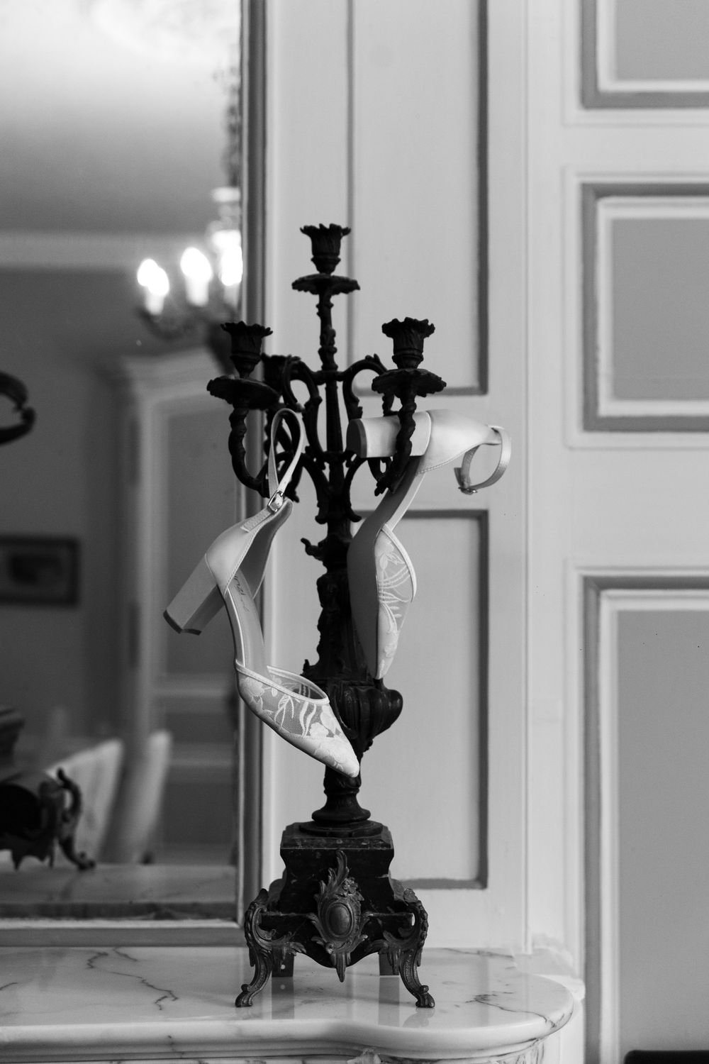 Elegant black candelabra displayed against white interior walls creates dramatic contrast.