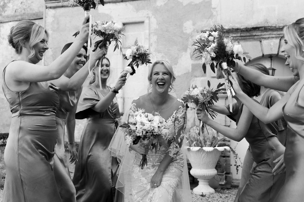 A black and white photo collage shows wedding party members dancing and celebrating at a reception.