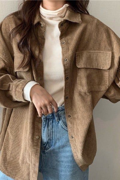 Tan corduroy shirt jacket styled with white turtleneck and blue jeans for casual autumn look.