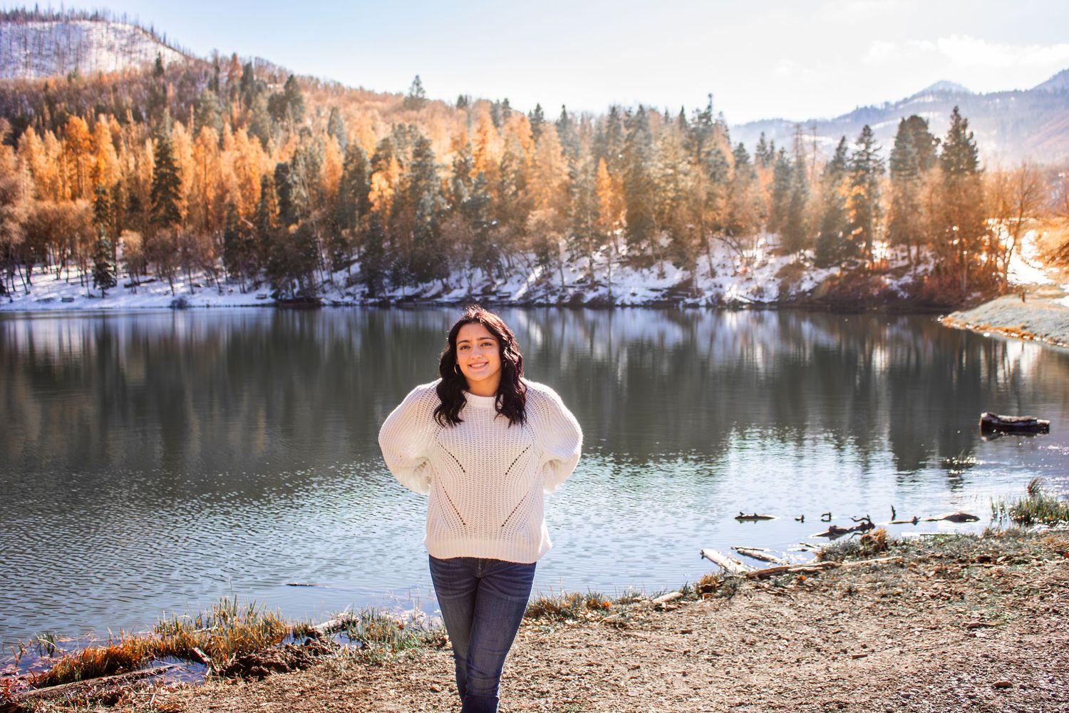 Solo portrait in front of Utah lake with fall leaves and fall trees in the background in Spanish Fork, Utah