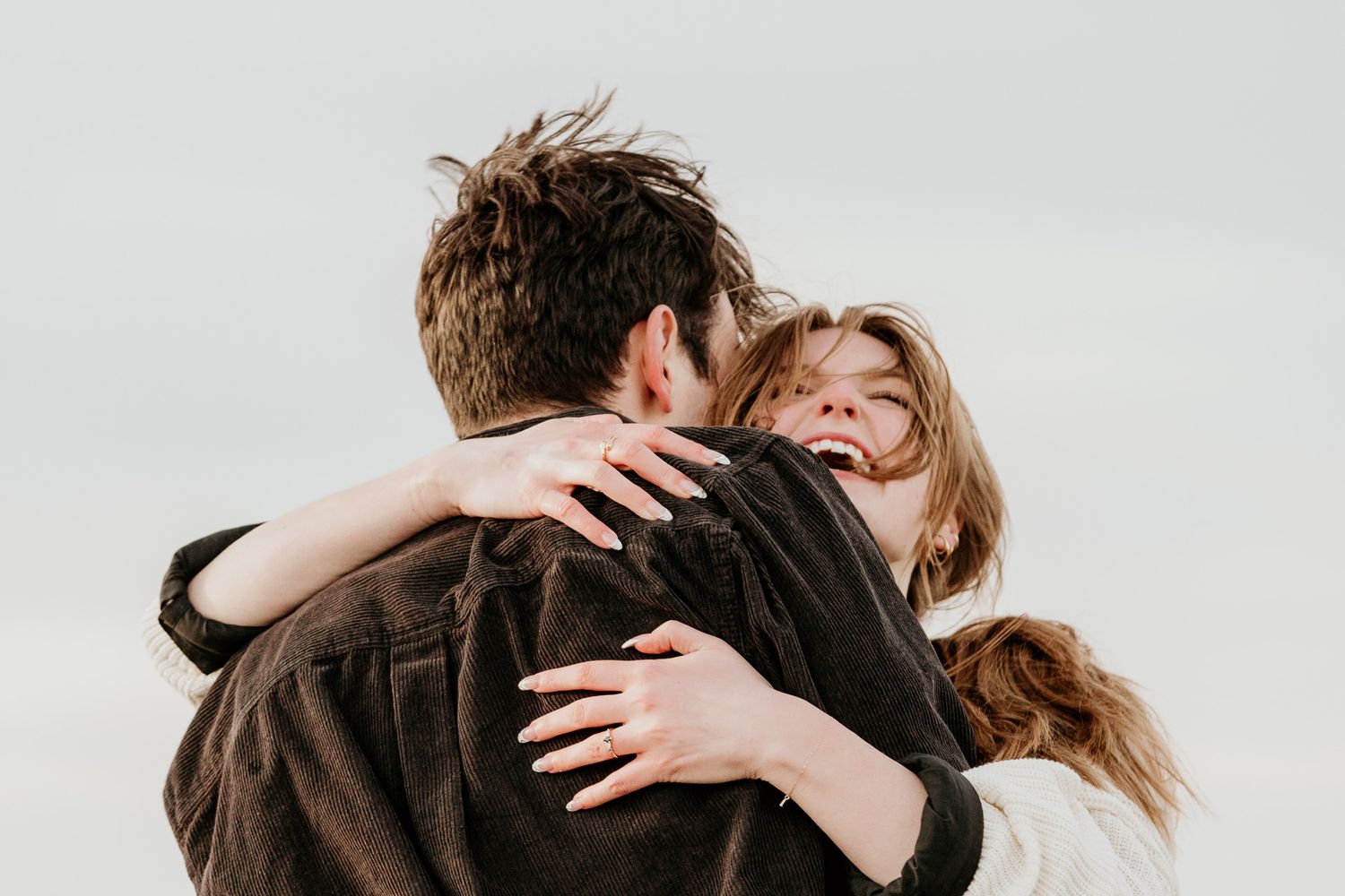 Engaged couple dancing at Mentor Headlands beach photographed by cleveland engagement photographer.