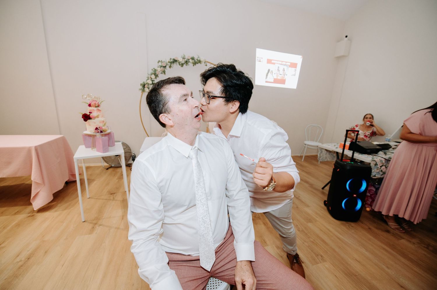 Intimate moment shared between couple during indoor wedding celebration.