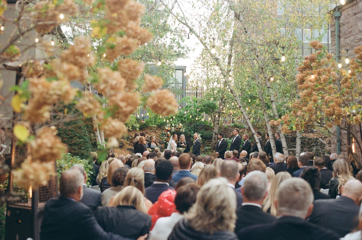 A detailed shot of the guests watching the bride and groom on film