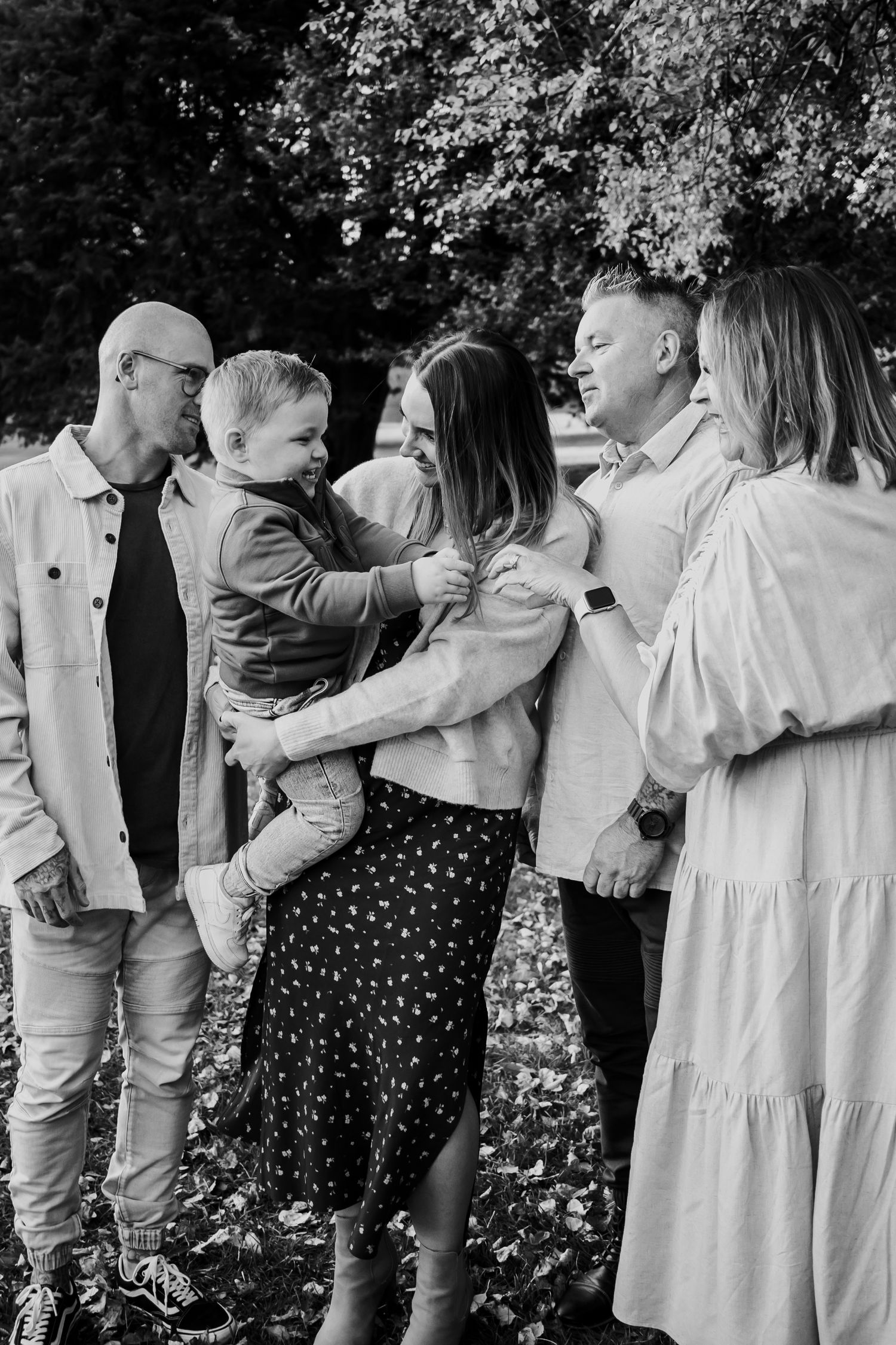 Family all standing and looking at one another.