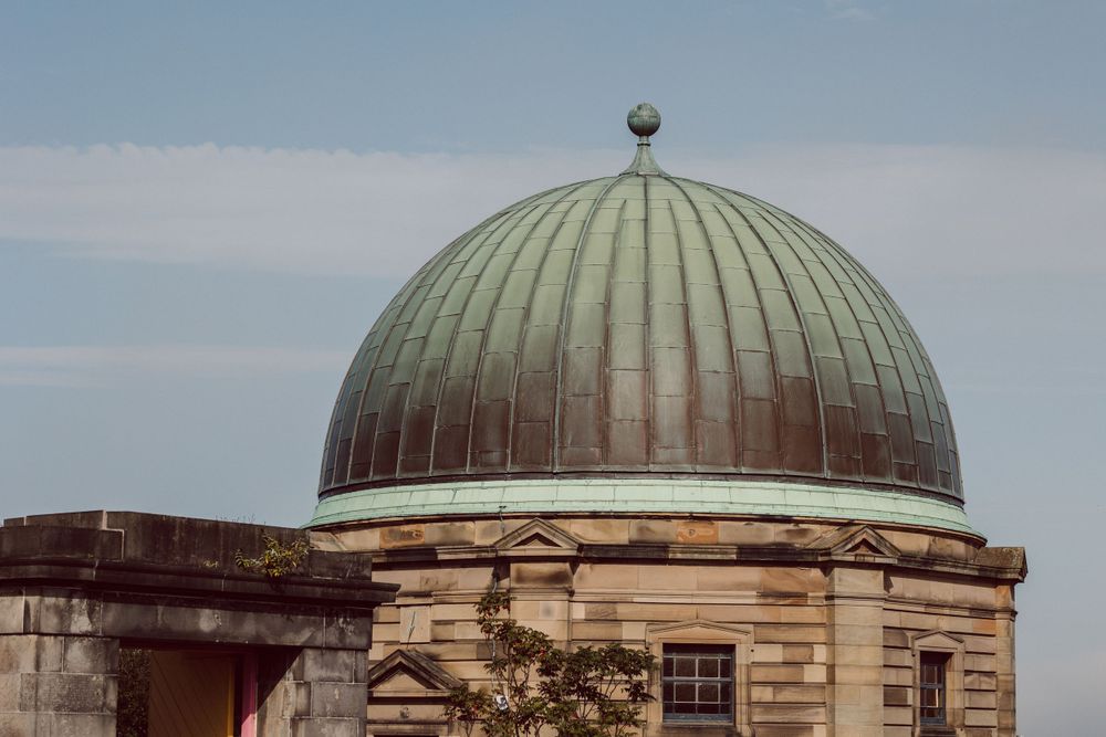 Classical domed architecture and stone buildings on Calton Hill in Edinburgh.