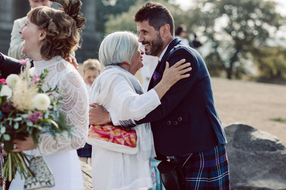 Joyful moments shared between wedding guests during outdoor celebration.