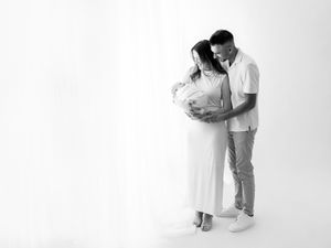 A romantic black and white photo series showing tender moments between a couple in minimalist studio setting.