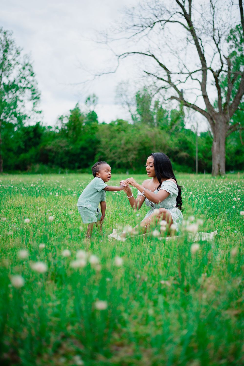 A joyful outdoor scene in a lush green field with spring flowers blooming.