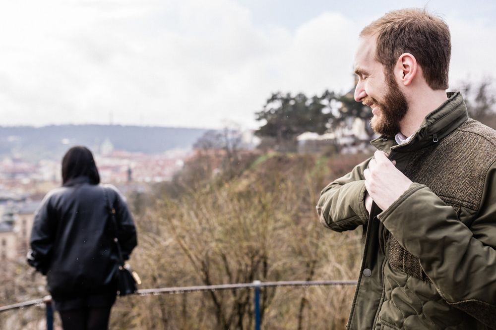 A series of profile views showing someone wearing a brown jacket against a blurred outdoor landscape background.