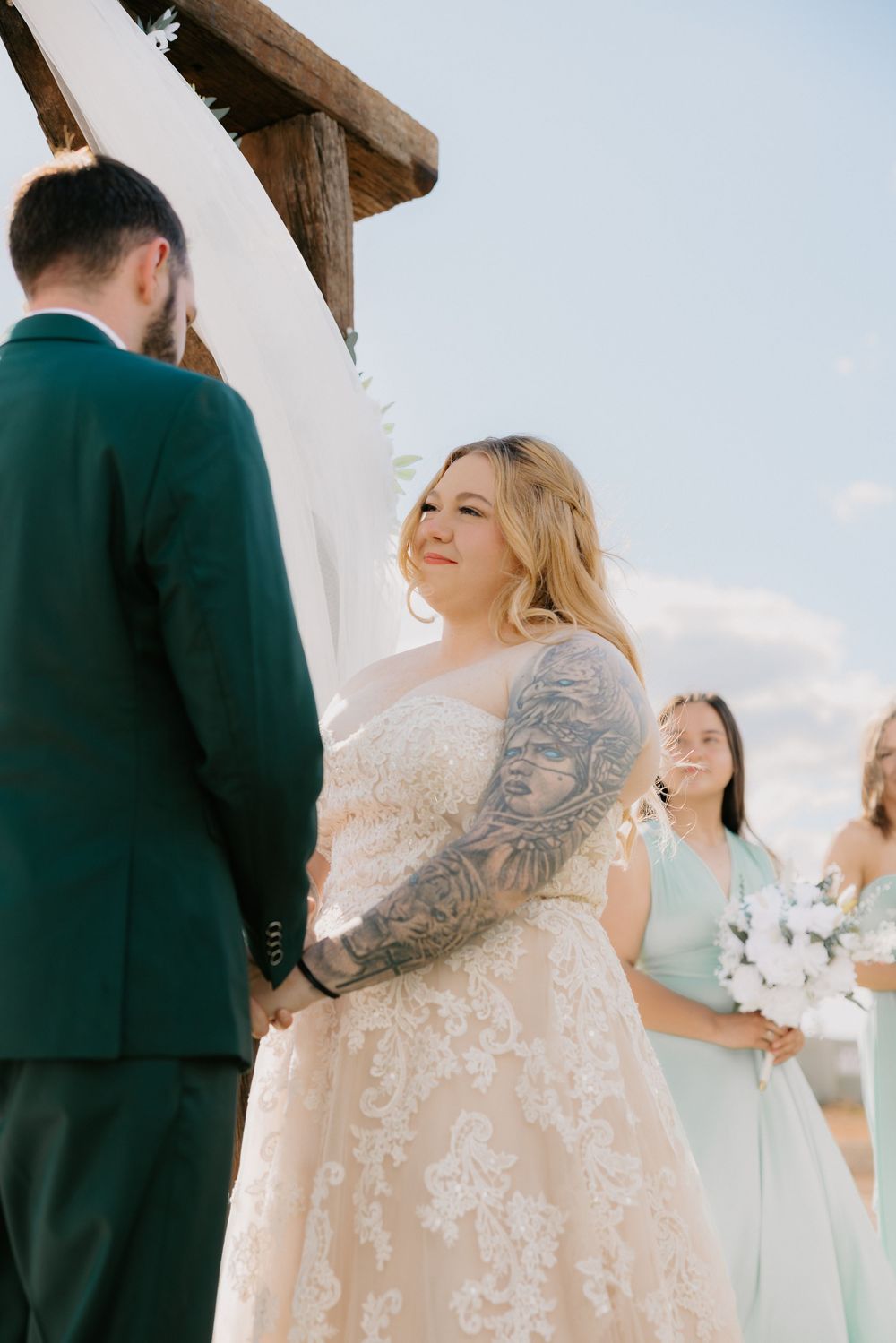 A wedding ceremony shows a couple in an outdoor venue with bridesmaids in mint green dresses.