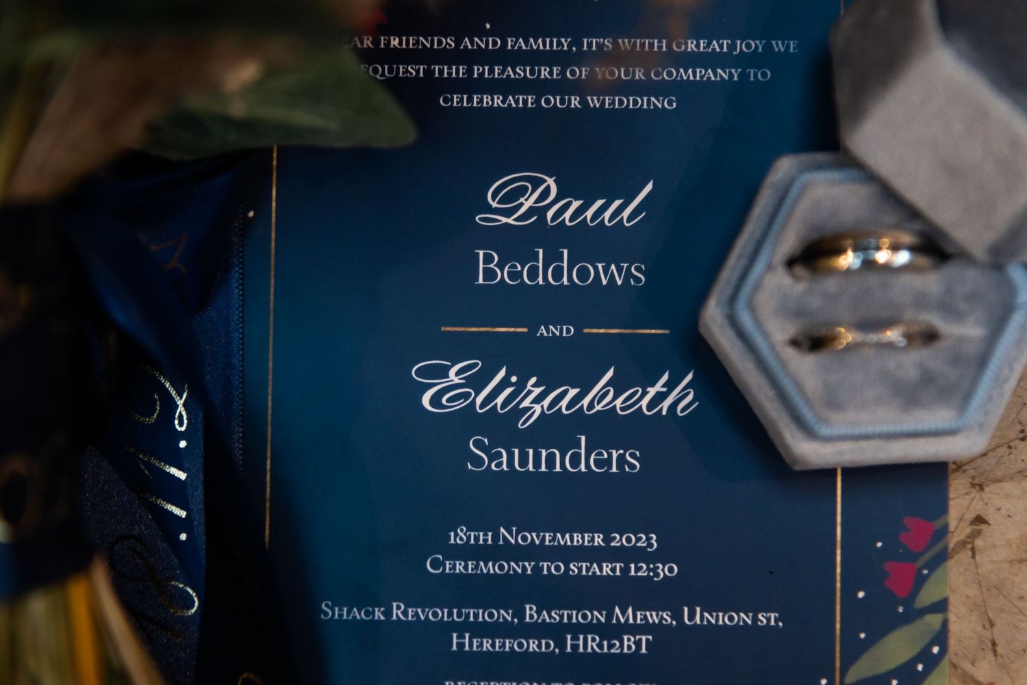 Wedding invitation suite with elegant navy blue design and calligraphy.