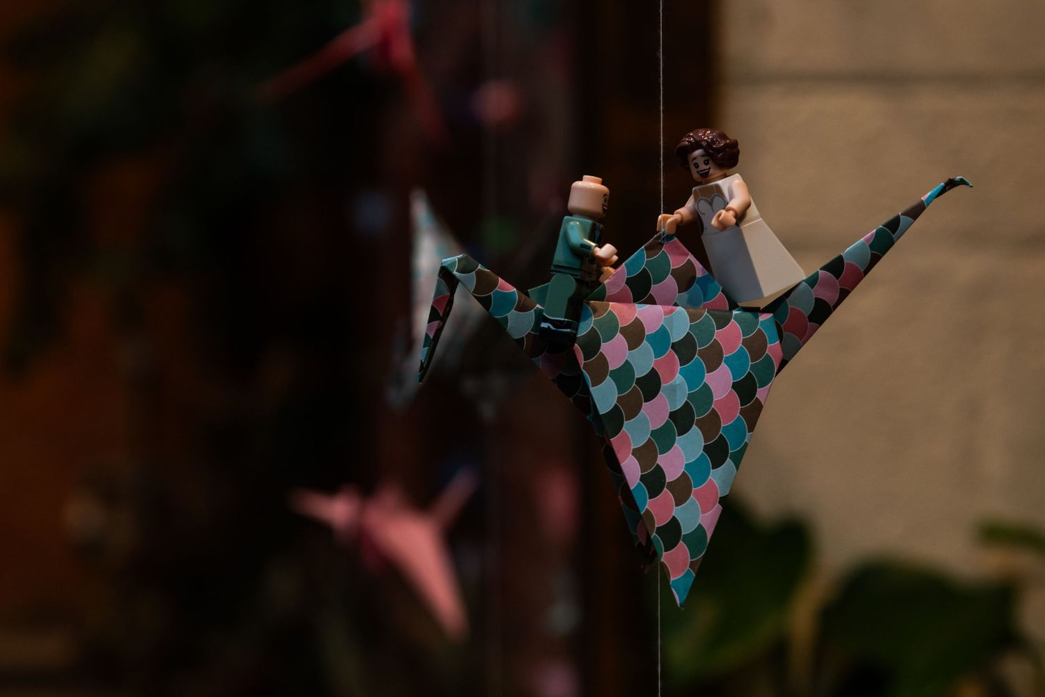 Colorful paper decorations hanging from above at a wedding celebration.