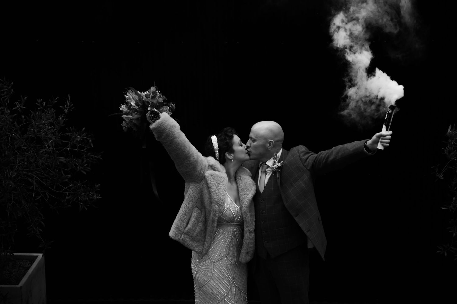Black and white dance celebration image with people celebrating at a wedding reception.