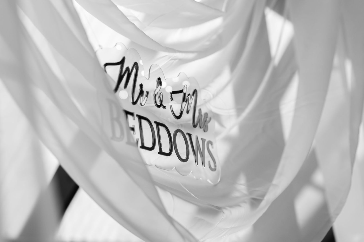 Close-up detail of embossed wedding stationery in white.