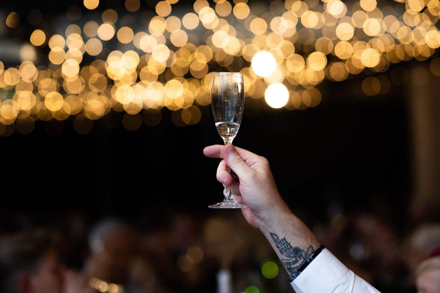 Warm bokeh lights creating romantic ambiance at wedding reception.