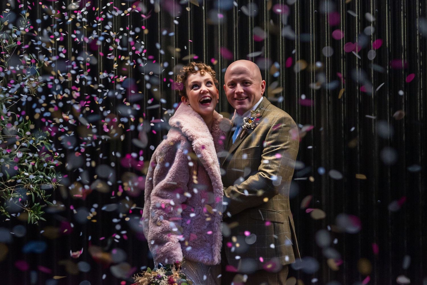 Colorful confetti falling during an indoor celebration.