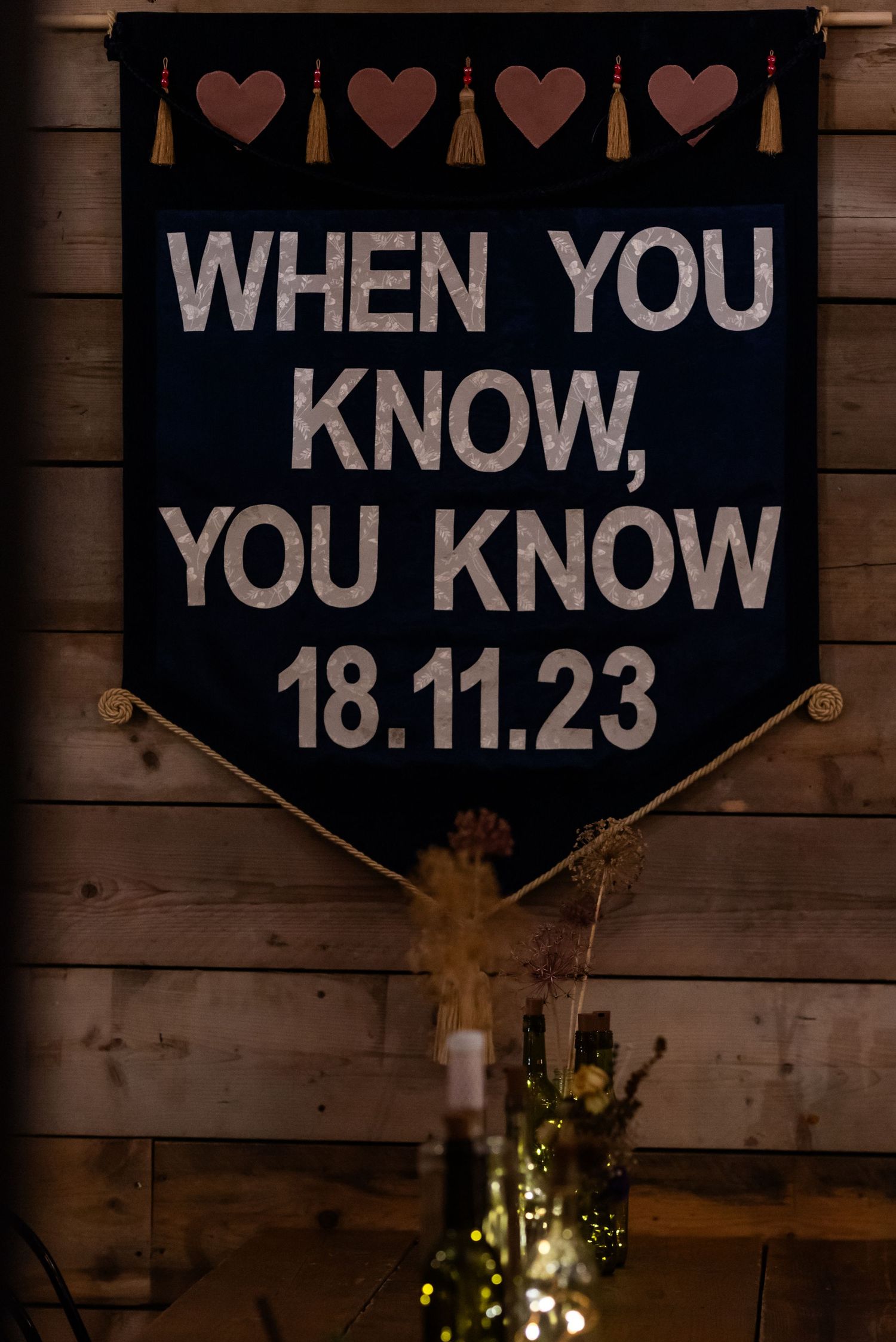Rustic wooden signs displaying 'When You Know' and a date at a wedding venue.