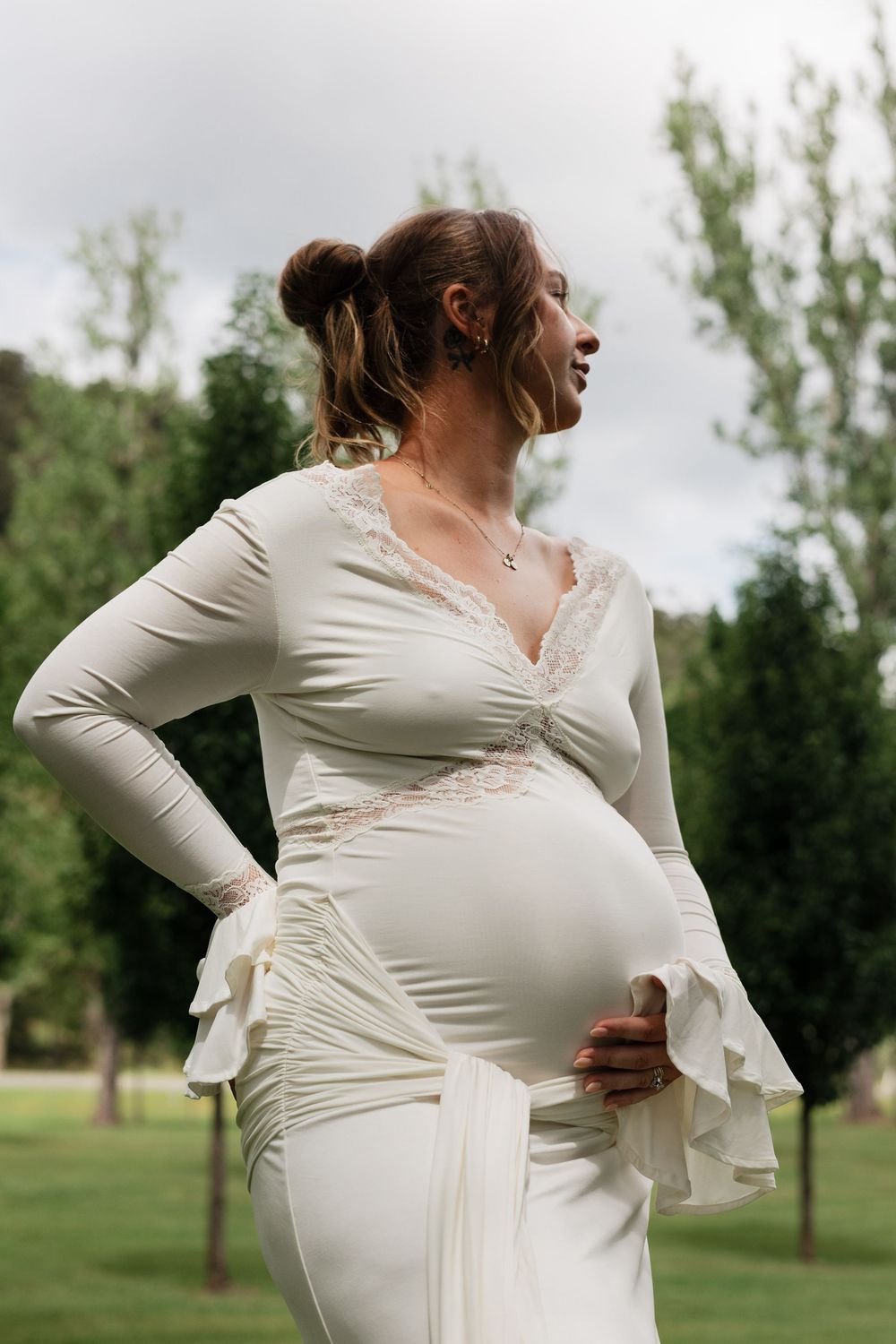 A series of photos showing a pregnant woman in a white dress posing in a grassy outdoor setting.
