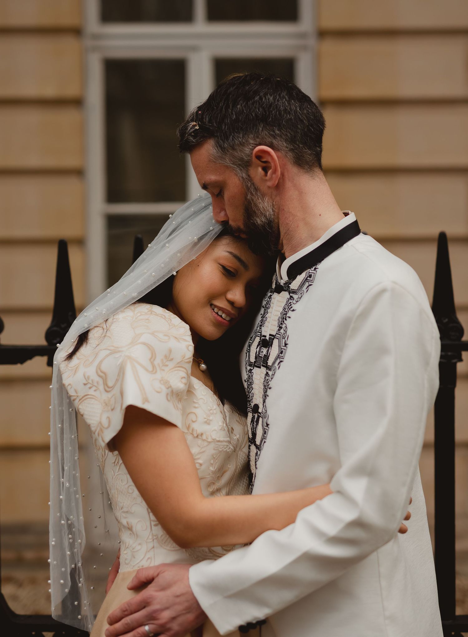 Couple in formal attire share intimate dance and embrace.