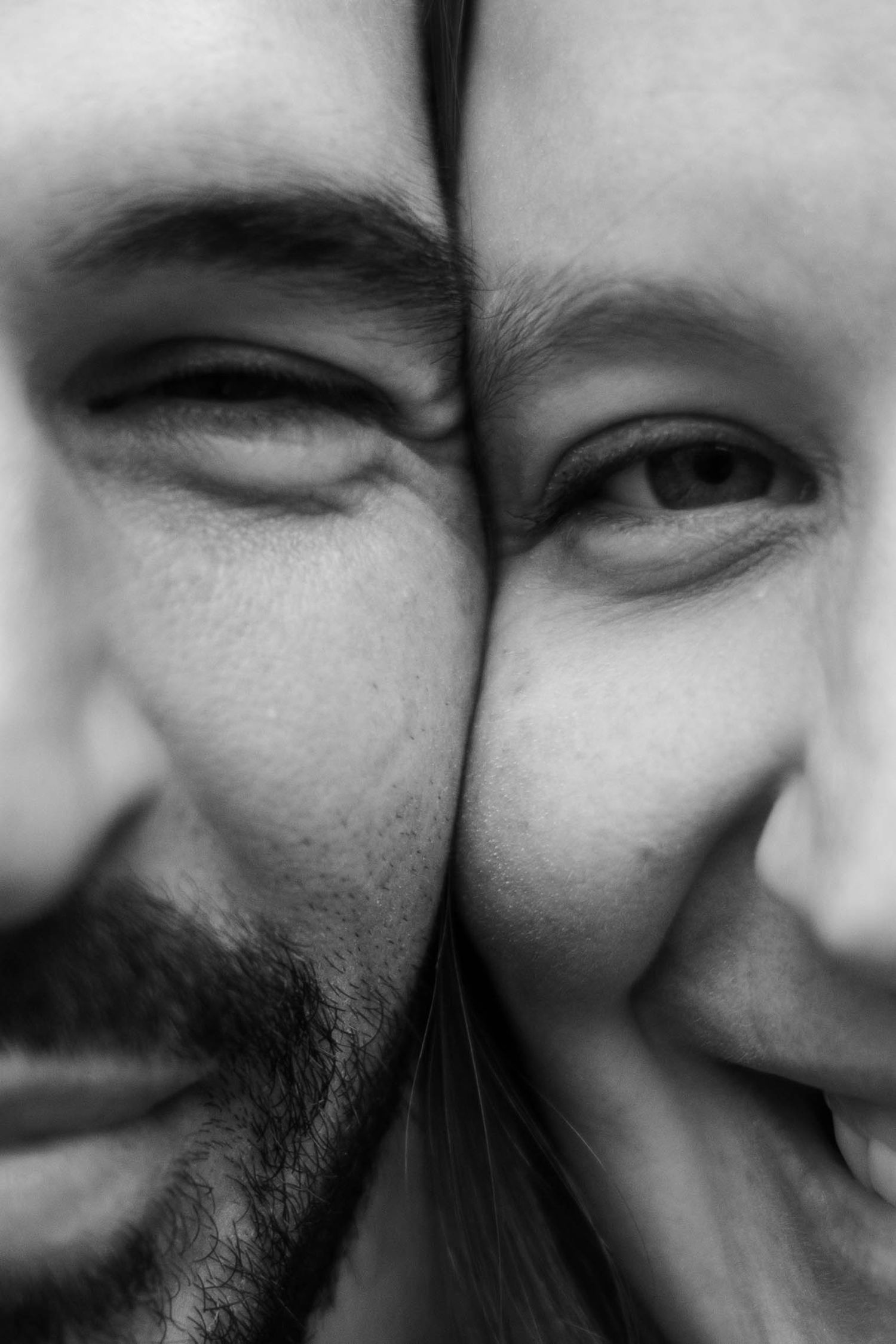Close-up black and white image showing expressions of joy and laughter.