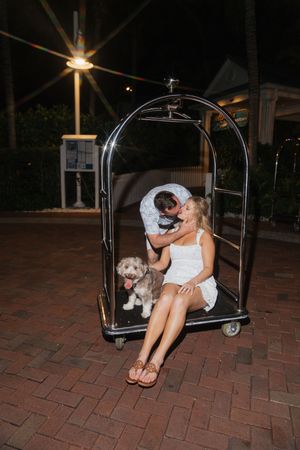 A playful series of wedding photos showing a couple in a golf cart at night on brick pavement.
