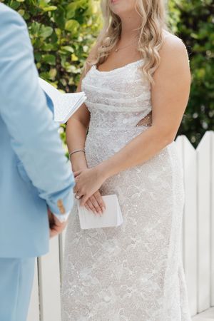 Close-up details of a sparkly white wedding dress with lace detailing.