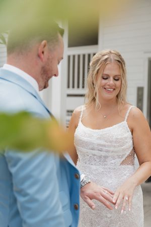 Close-up sequence showing a white lace wedding dress with delicate details and straps.