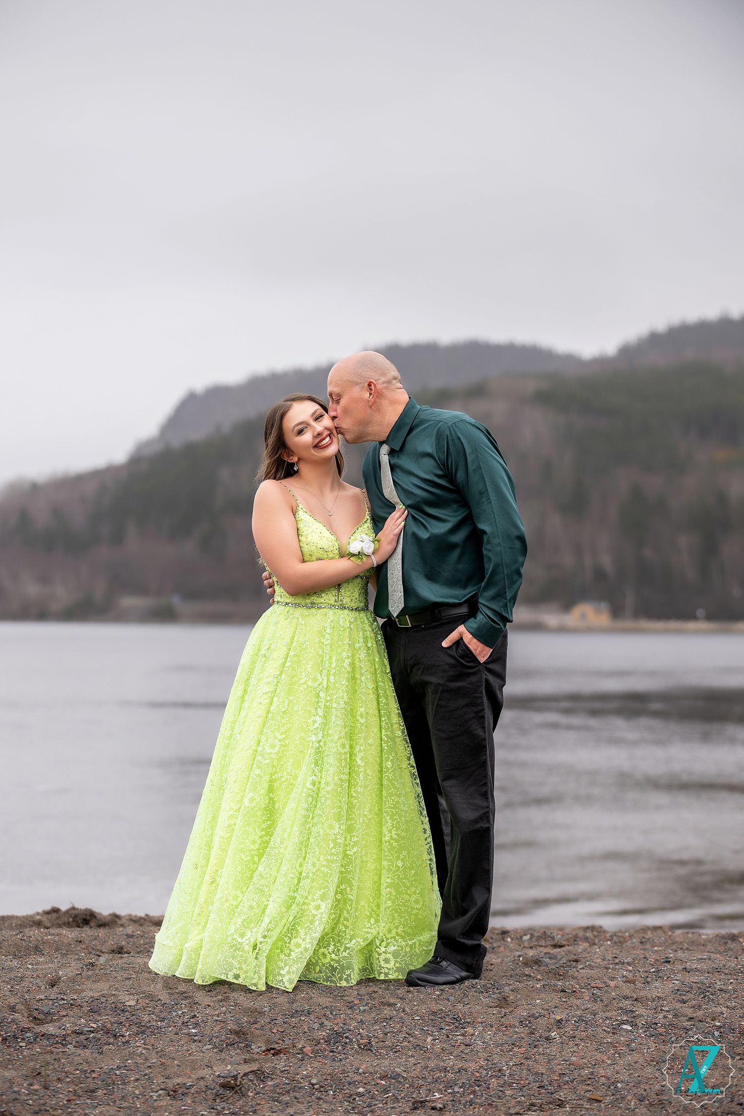 A romantic moment captured by the water with a lime green gown contrasting against the moody landscape.