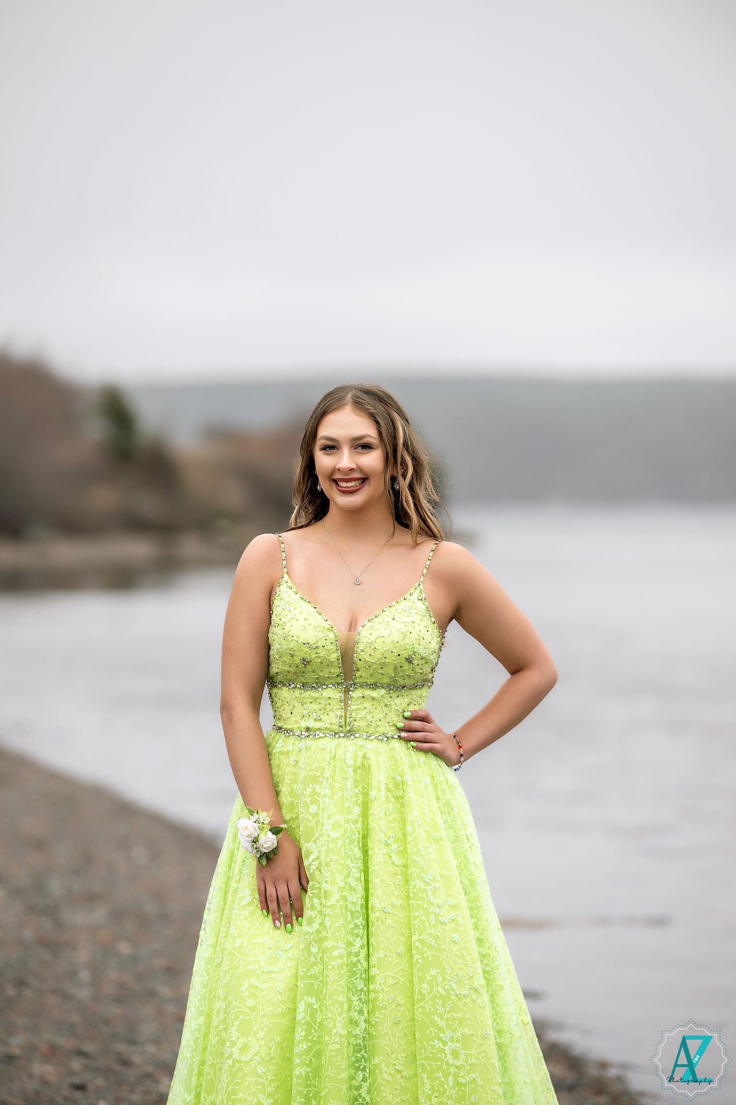 A stunning lime green ball gown sparkles against a moody coastal landscape.