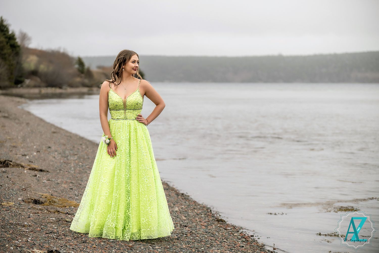 A sparkling lime green formal dress stands out beautifully against a rocky coastal setting.
