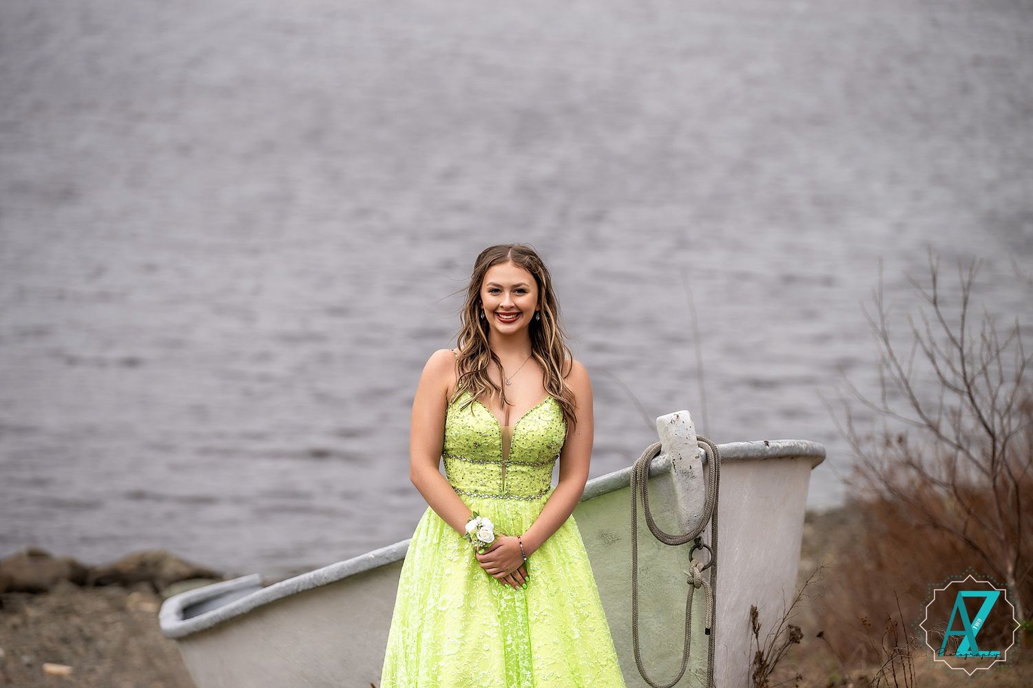 A formal photo by the water featuring a bright lime green sequined gown.