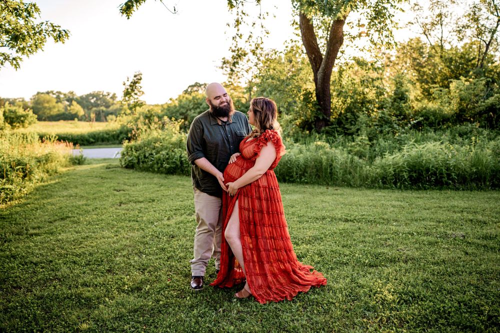 A romantic evening portrait in a lush garden setting with warm lighting.