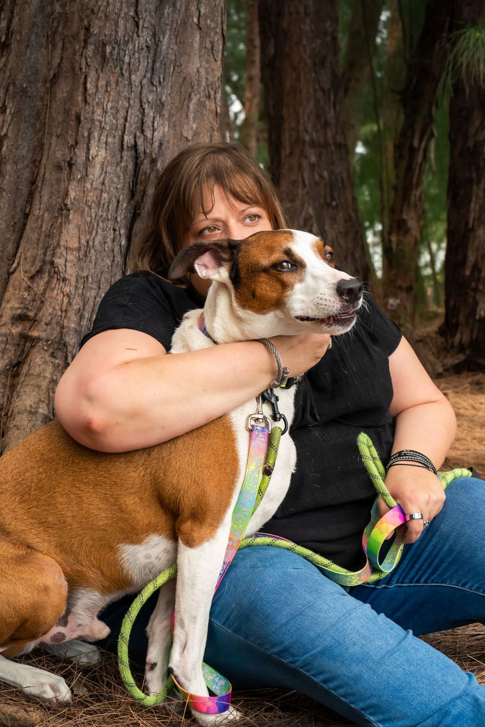 Mom sitting with her dogs during a relaxed lifestyle portrait session, heartfelt pet and family photography by SRX Media Group in S. Florida