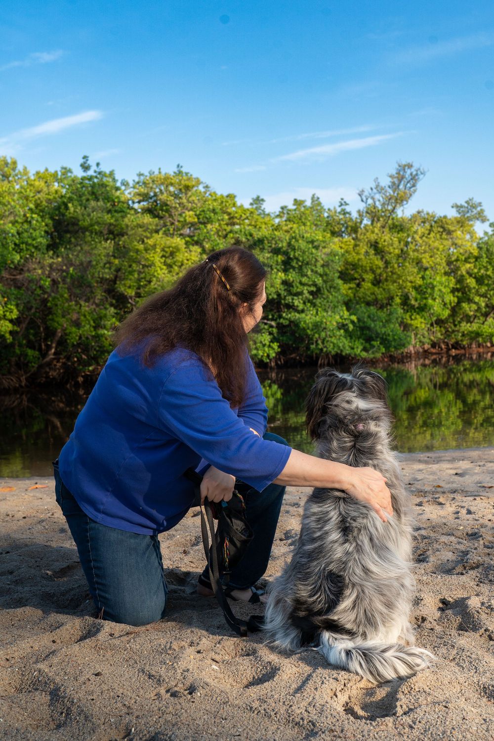 Mom sitting with her dogs during a relaxed lifestyle portrait session, heartfelt pet and family photography by SRX Media Group in S. Florida