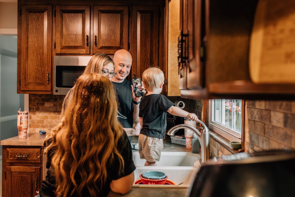 family in kitchen FaceTiming with grandparents, documentary family photography, Whitney Popp