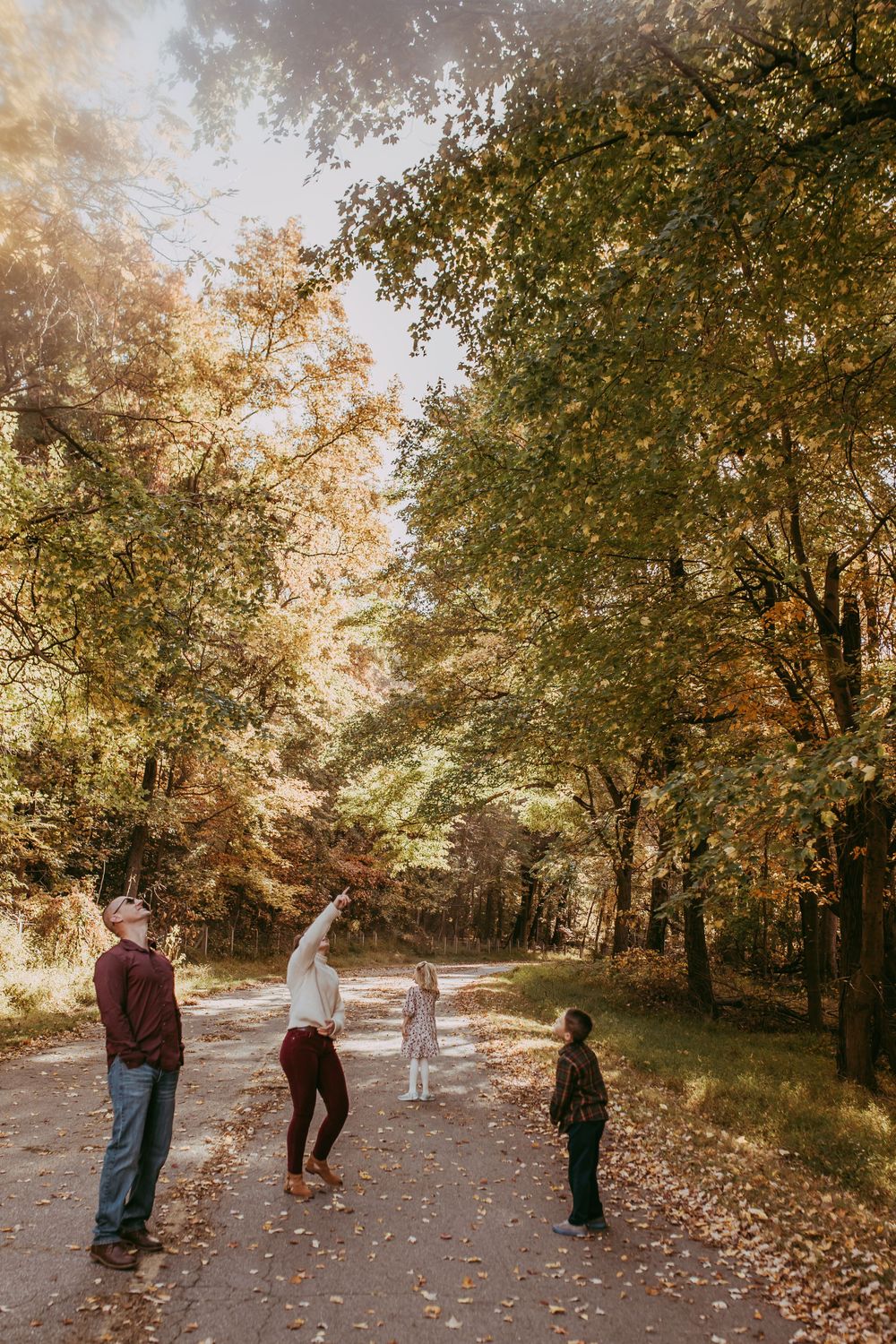 family walking under fall leaves, family documentary family photography Whitney Popp