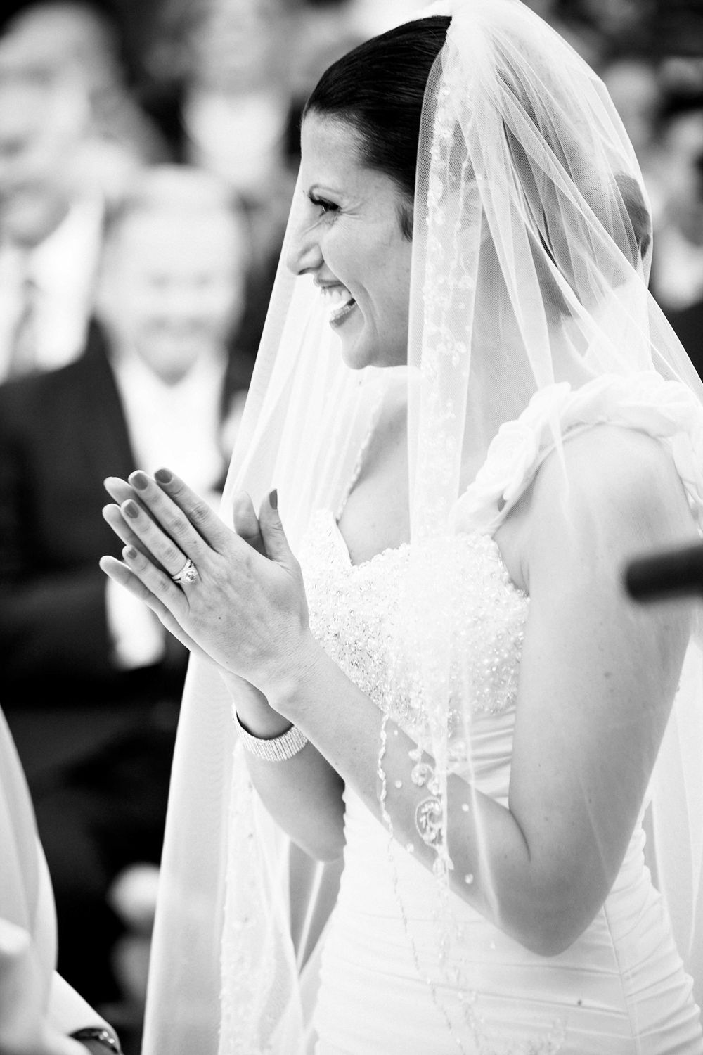 A series of candid black and white photos showing an emotional bride in her wedding veil during the ceremony.
