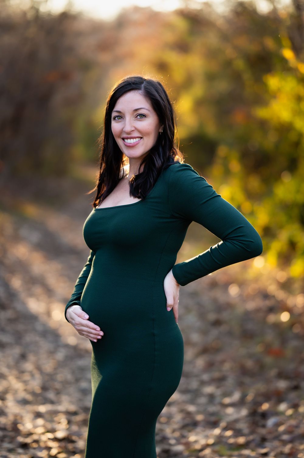 dallas area soon-to-be mom holds her bump during golden hour outdoor sunset maternity photo session by mesquite, tx family photographer