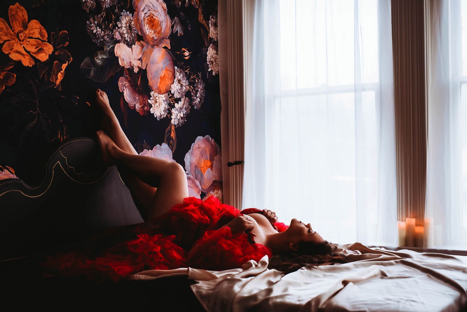Woman poses on bed during her boudoir session with Megan Kathleen Boudoir