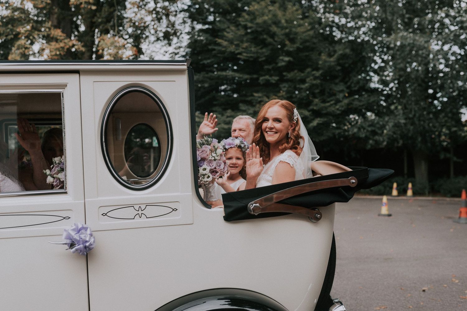 Bride with her flower girls and bridesmaids arriving in a luxury classic car at Langton house in Hornchuch
