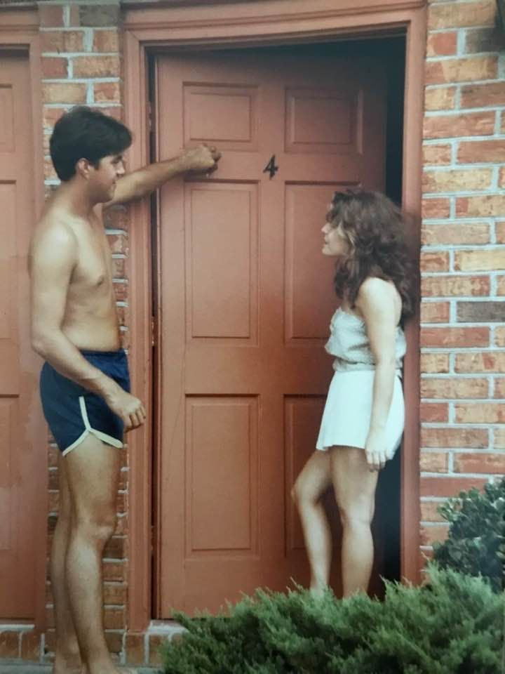 man and woman hanging out on their front steps of their townhouse apartment