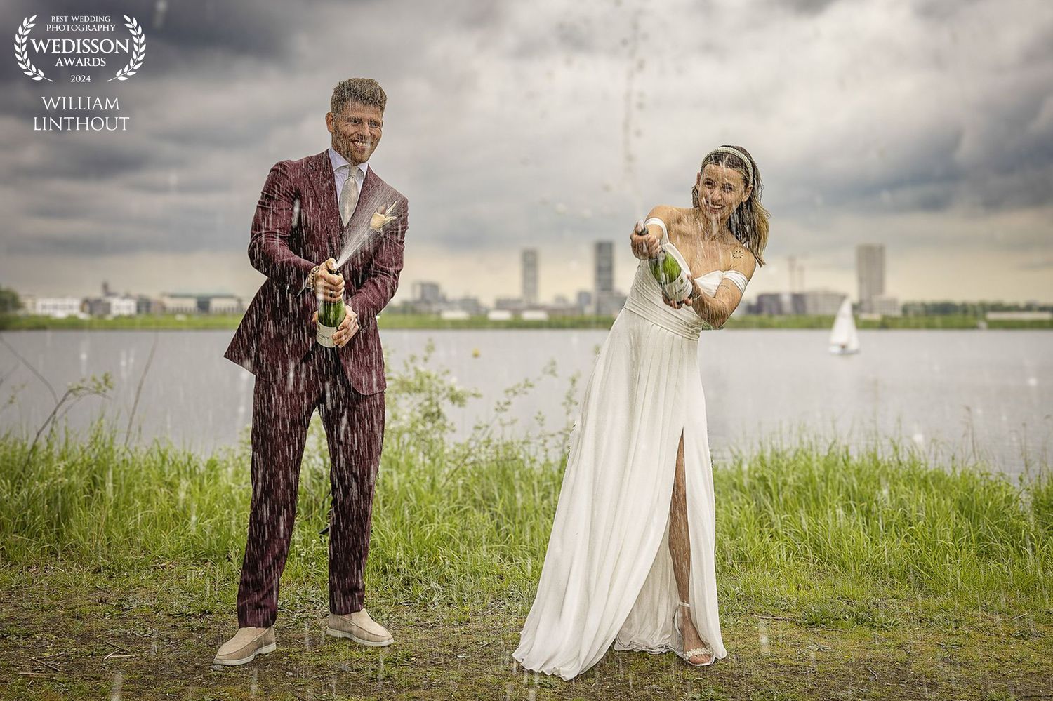 Wedding couple in dramatic pose with bouquet against stormy sky and urban backdrop.