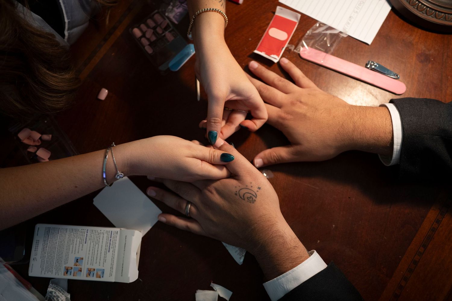 Close-up shot of hands exchanging rings during a wedding ceremony.