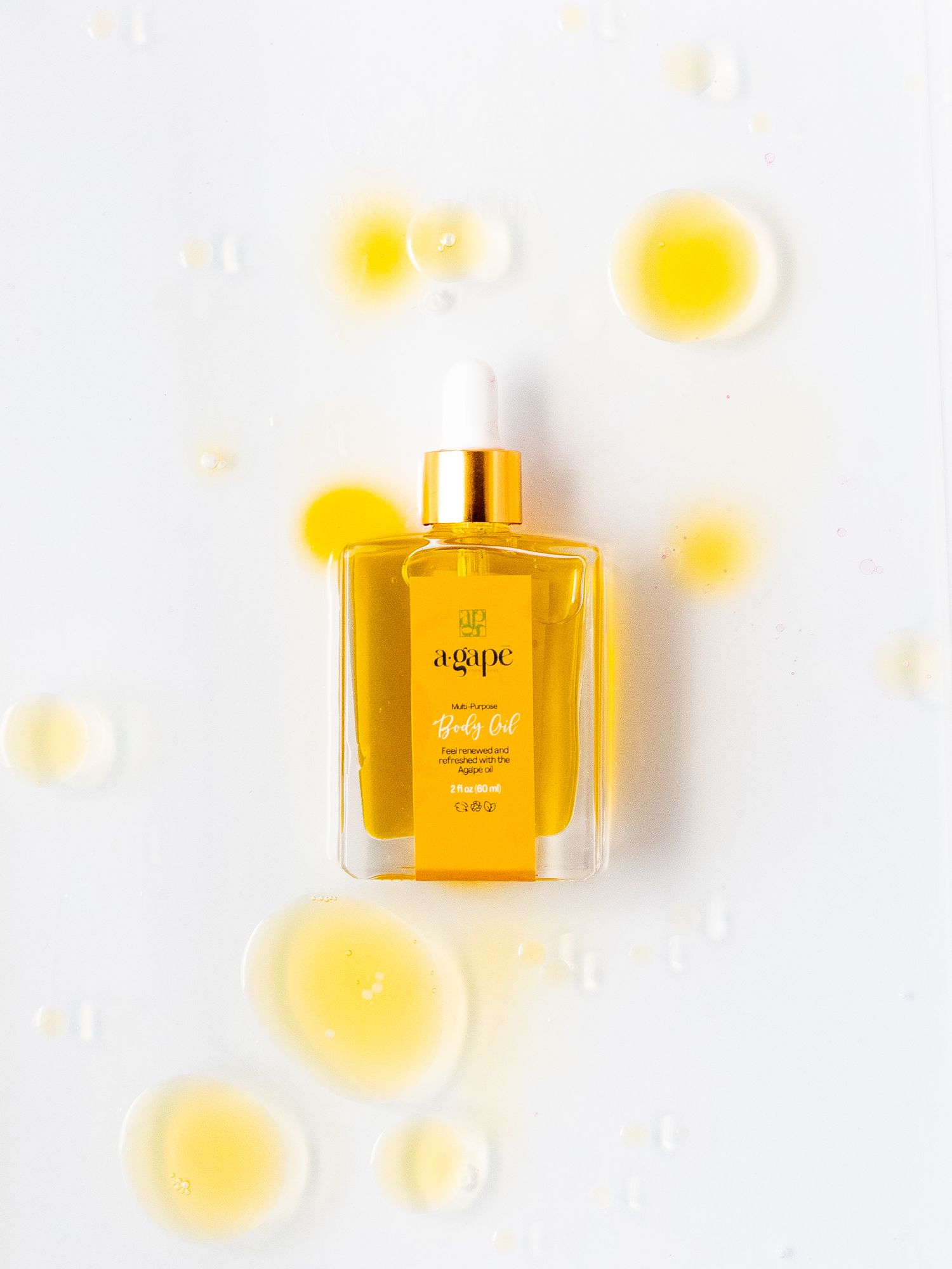 Golden facial oil serum bottle on white background with yellow light effects.