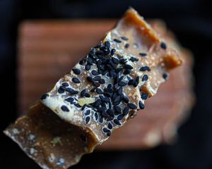 Close-up of gourmet chocolate bar topped with black salt crystals.