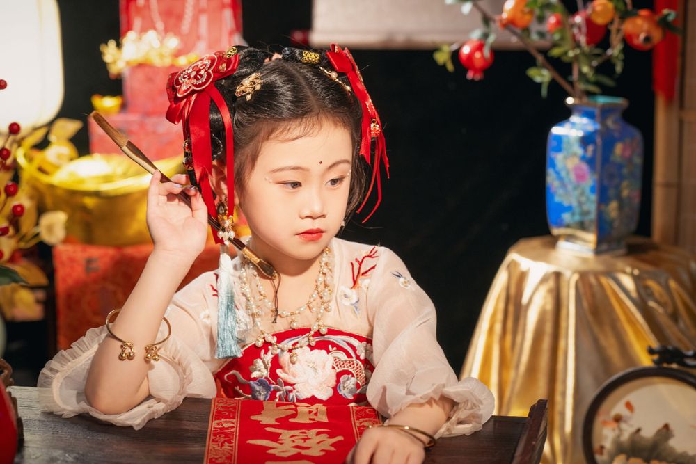 Cute children's studio portrait in an elegant Tang Dynasty Hanfu with dazzling golden props, by Imagine Image Studio.