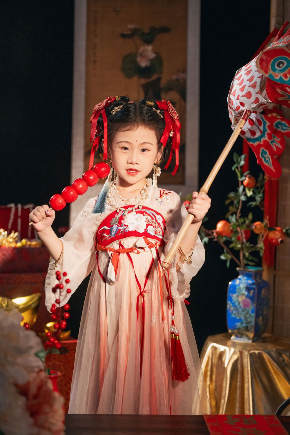 Cute children's studio portrait in an elegant Tang Dynasty Hanfu with dazzling golden props, by Imagine Image Studio.